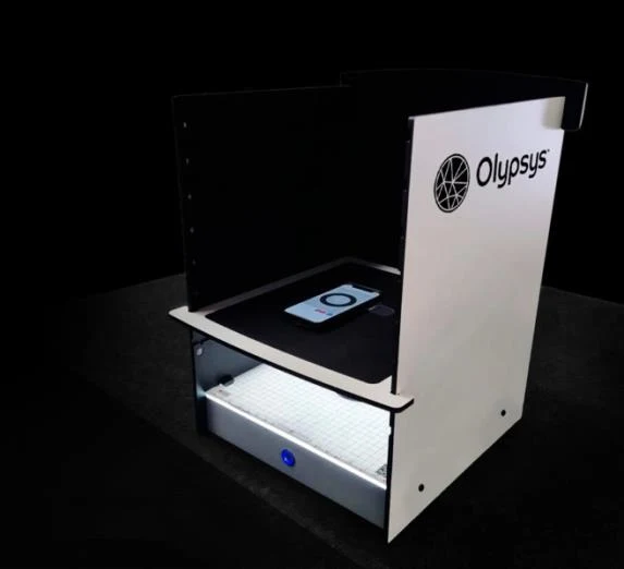 Olypsys Pro-Vision Booth with smartphone mounted in the top cradle and backlit calibration grid illuminated below